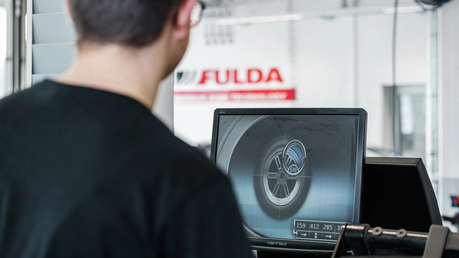 Apprenti vérifiant un pneu sur l'ordinateur.